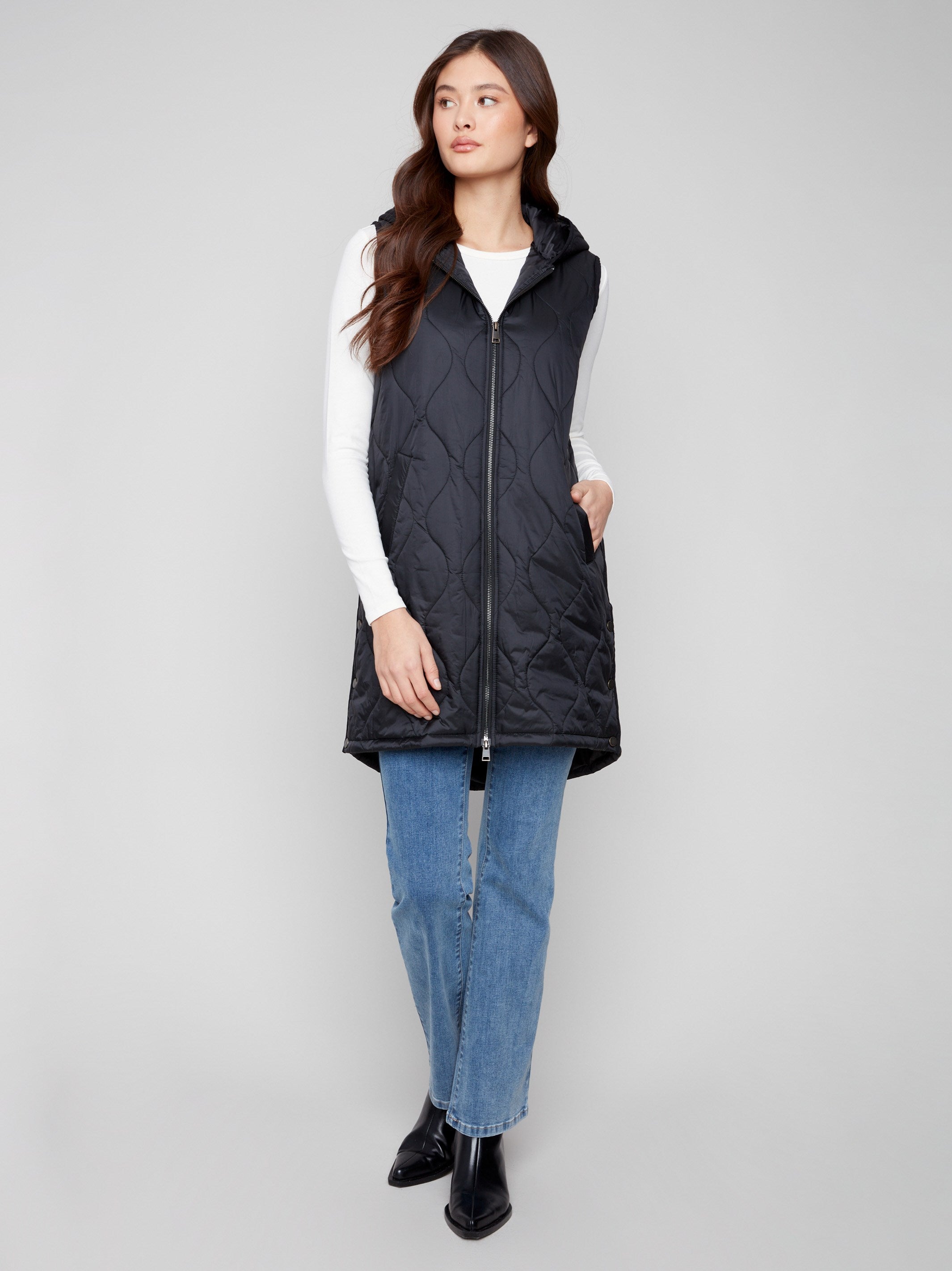 Black hooded vest showcasing practical side snap buttons for customizable fit by Charlie B.