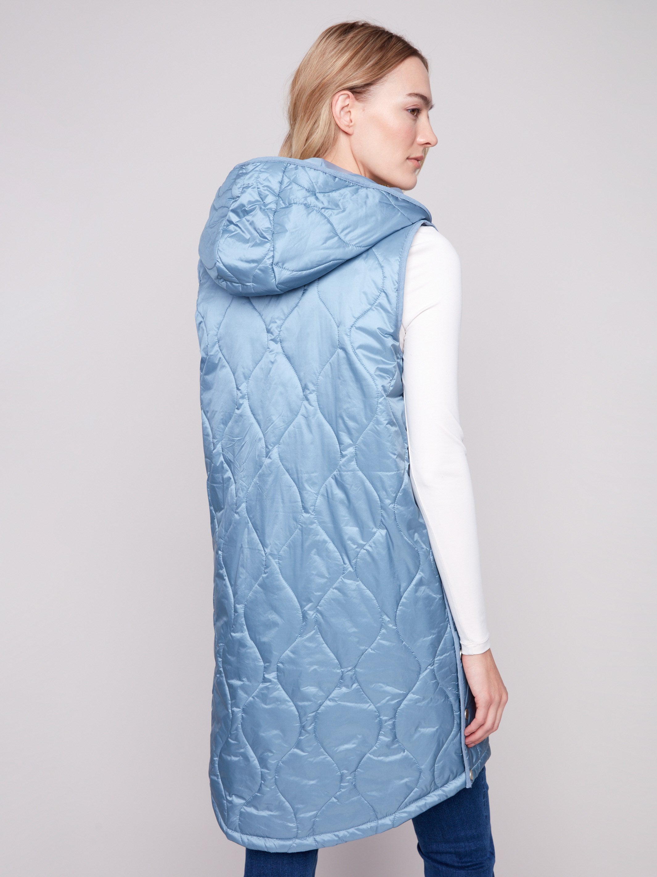 Elegant hooded vest showcasing side snap buttons for versatility by Charlie B.