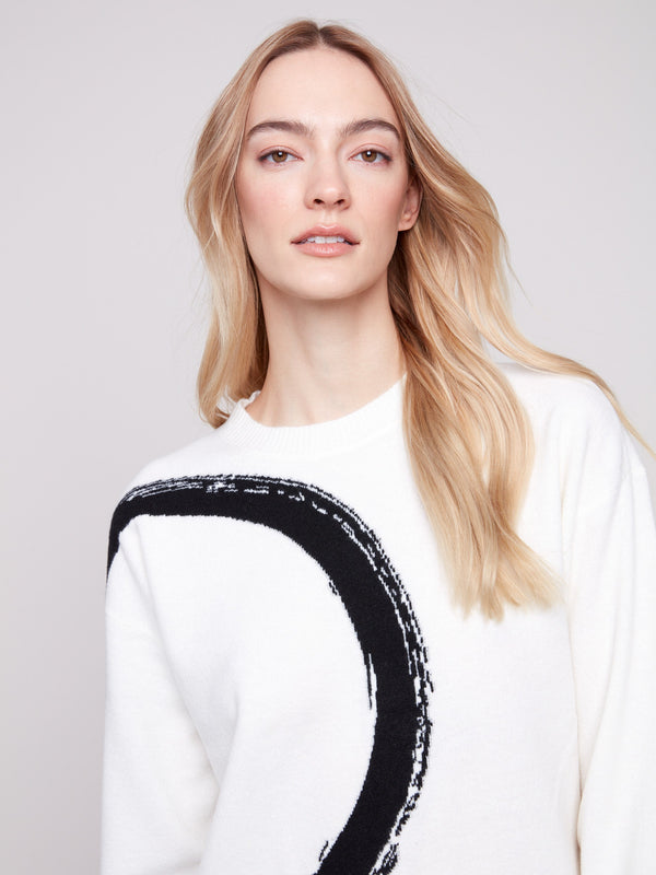 Relaxed fit ecru sweater adorned with a bold black abstract circle pattern for casual elegance by Charlie B.