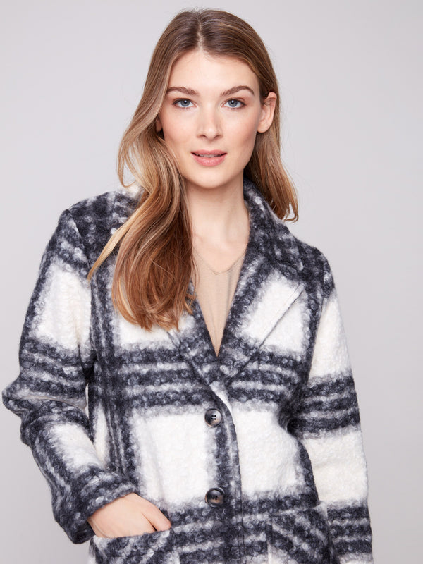 Stylish plaid coat crafted from boucle knit fabric, showcasing a sophisticated button-front closure and modern design by Charlie B.