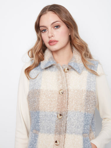 Featuring welt pockets, this sleeveless plaid vest combines practicality with chic style for everyday wear. By Charlie B.