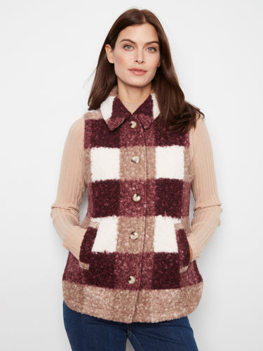 This sleeveless plaid vest is designed with welt pockets, perfect for keeping your hands warm or storing small essentials. By Charlie B.