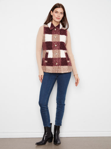 Timeless style meets practicality in this sleeveless plaid vest with functional welt pockets, enhancing both form and function effortlessly. By Charlie B.
