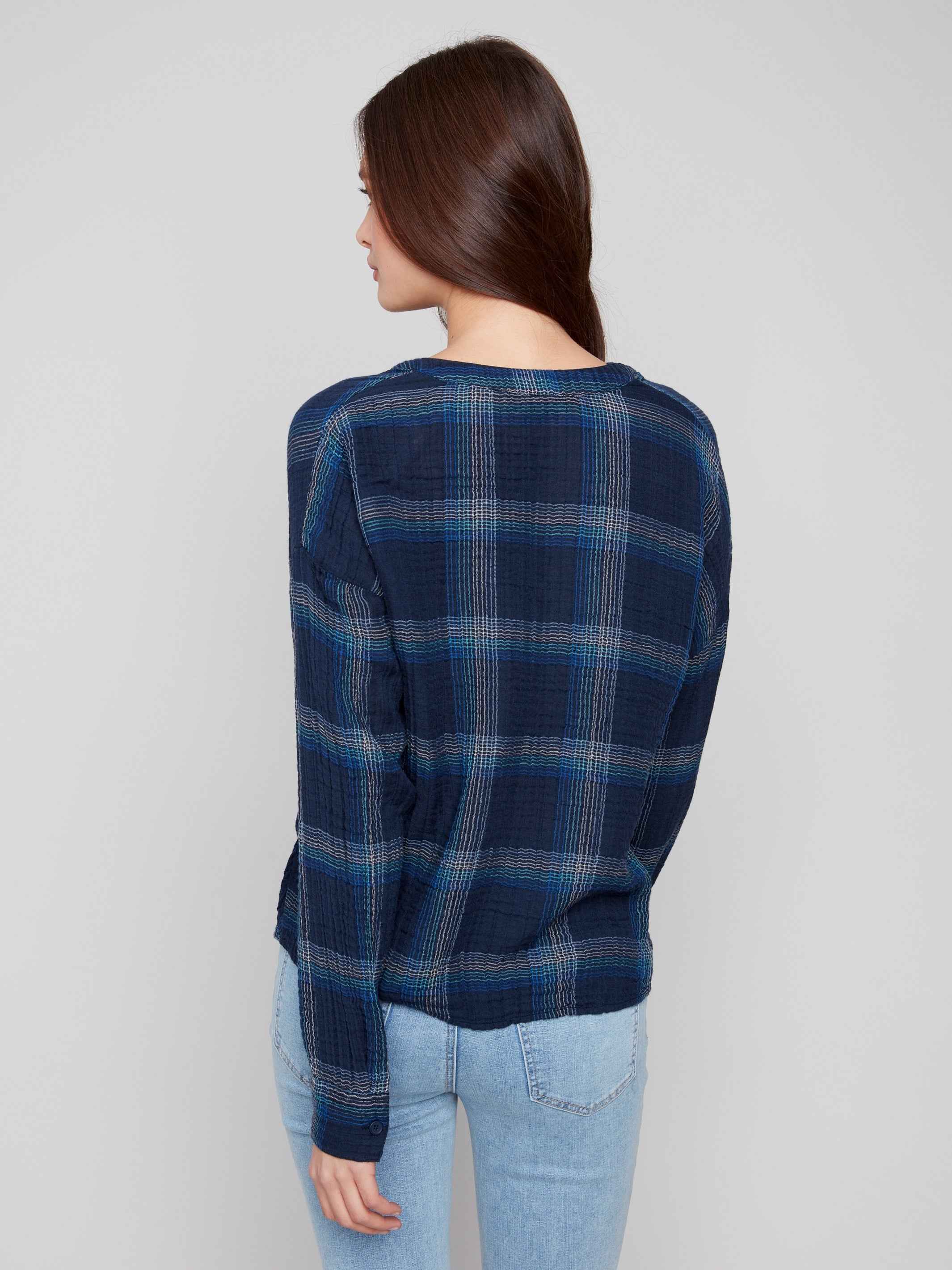 Stylish blue plaid blouse showcasing a unique front knot detail for added flair by Charlie B.