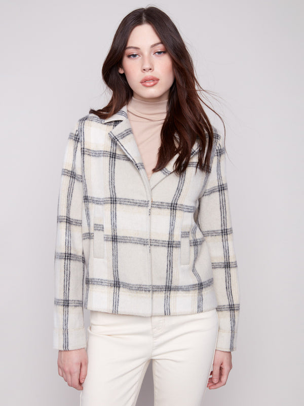 Beige plaid short coat with tailored collar and long sleeves, featuring hidden snap buttons and welt pockets by Charlie B.