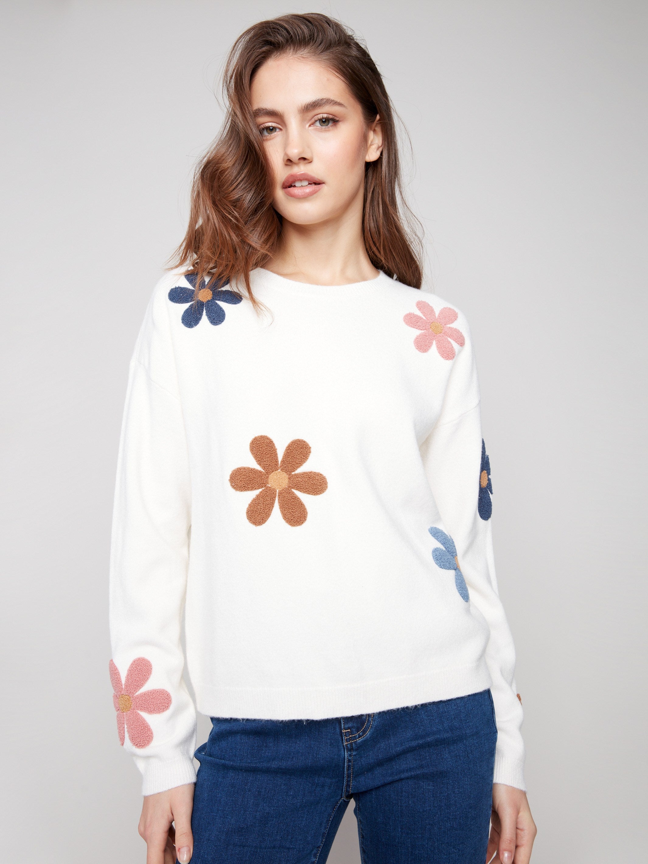 Ecru plush sweater with a crew neckline and vibrant boucle flower details for a playful touch by Charlie B.