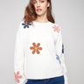 Ecru plush sweater with a crew neckline and vibrant boucle flower details for a playful touch by Charlie B.