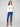 Ecru plush sweater showcasing drop shoulder design, adorned with colorful boucle flowers by Charlie B.