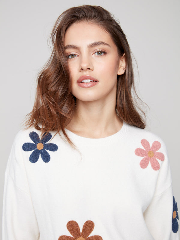 Ecru plush sweater crafted from soft fabric, accented with cheerful boucle flower patterns by Charlie B.