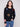 Black plush sweater with a classic crew neckline adorned with colorful boucle flower patches for a vibrant touch by Charlie B.