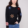 Black plush sweater with a classic crew neckline adorned with colorful boucle flower patches for a vibrant touch by Charlie B.