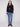 Stylish black sweater featuring drop shoulder design and vibrant boucle flower accents for modern flair by Charlie B.