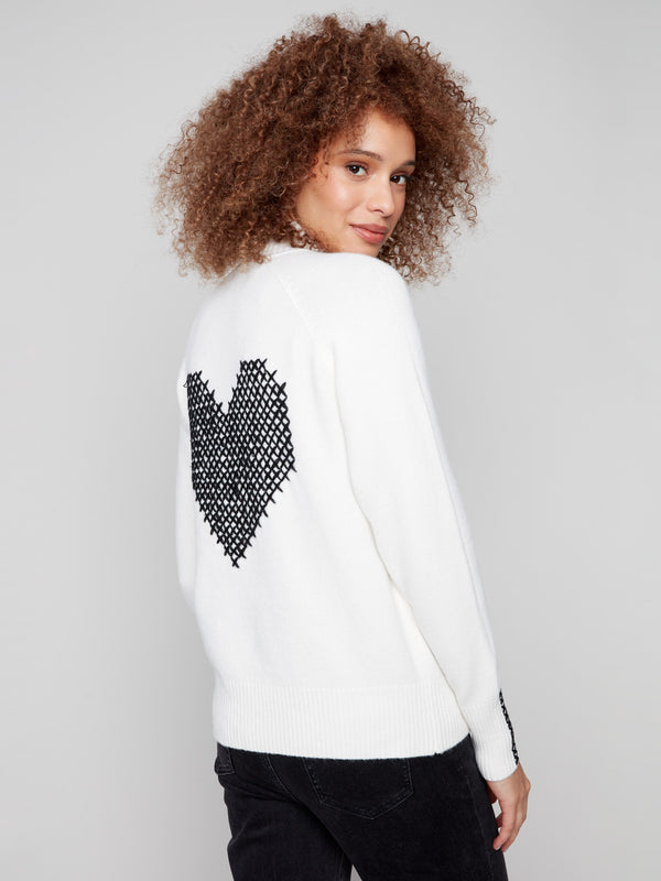 Chic ecru sweater displaying intricate stitching along the sleeves, enhancing its sophisticated look by Charlie B.