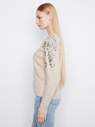 This chic sweater boasts a comfortable crew neckline and eye-catching sequins on the shoulders for added flair. By Charlie B.