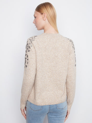 A versatile long-sleeve sweater highlighted by sparkling sequins on the shoulders, ideal for layering. By Charlie B.