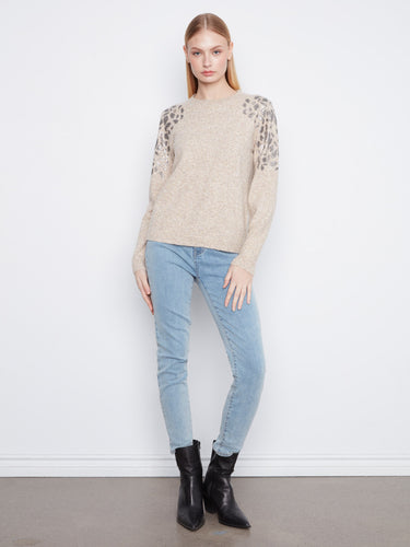 Sophisticated design with crew neckline and dazzling shoulder sequins, this piece elevates any wardrobe. By Charlie B.