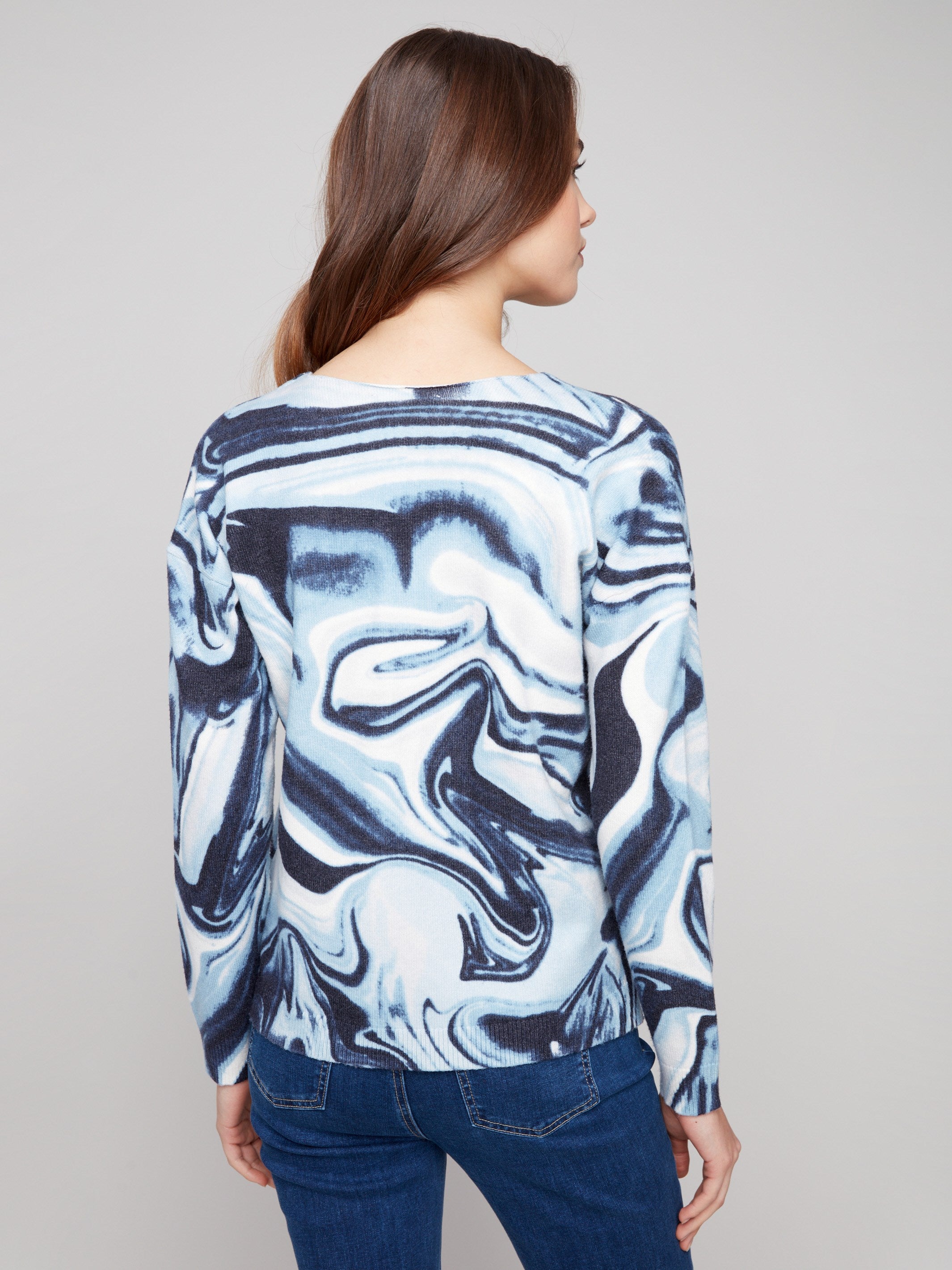 Elegant blue swirl sweater highlighted with practical side slits for ease of movement by Charlie B.