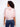 Pink polka dot top highlighting its semi-sheer fabric, ideal for layering in style by Charlie B.