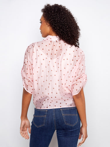 Pink polka dot top highlighting its semi-sheer fabric, ideal for layering in style by Charlie B.