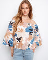 This top features a charming off-the-shoulder design, perfect for a relaxed yet stylish look. By Charlie B.