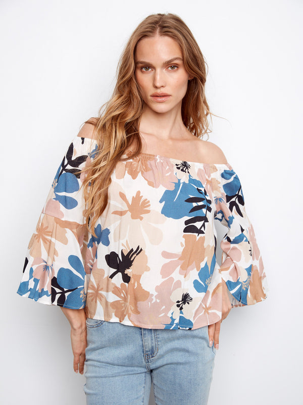 This top features a charming off-the-shoulder design, perfect for a relaxed yet stylish look. By Charlie B.