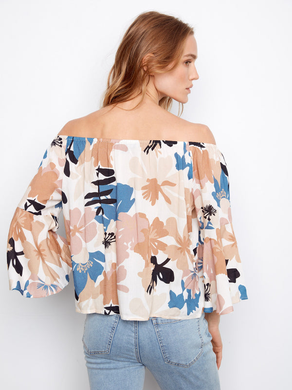 The off-the-shoulder neckline complements the floral design beautifully, offering an effortlessly chic style. By Charlie B.