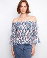 Blouse featuring an off-the-shoulder design with a colorful abstract pattern in lightweight fabric by Charlie B.