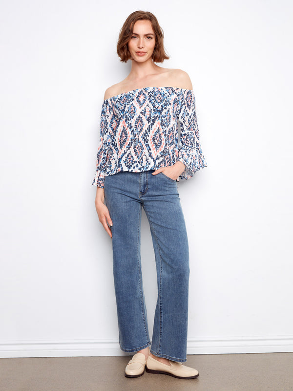 Lightweight fabric blouse showcasing a vibrant abstract pattern and off-the-shoulder style by Charlie B.