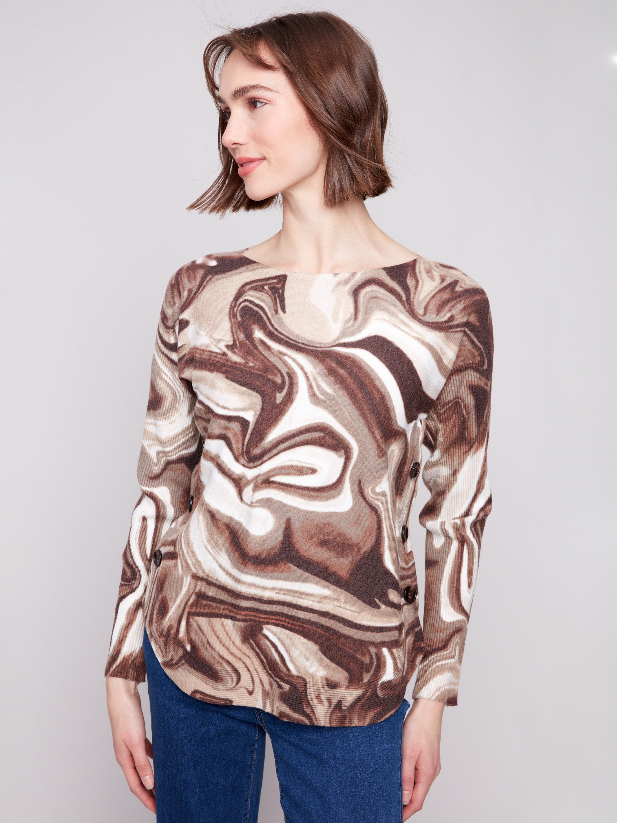 Stylish long-sleeve sweater with side button details, adding flair to the swirl design by Charlie B.