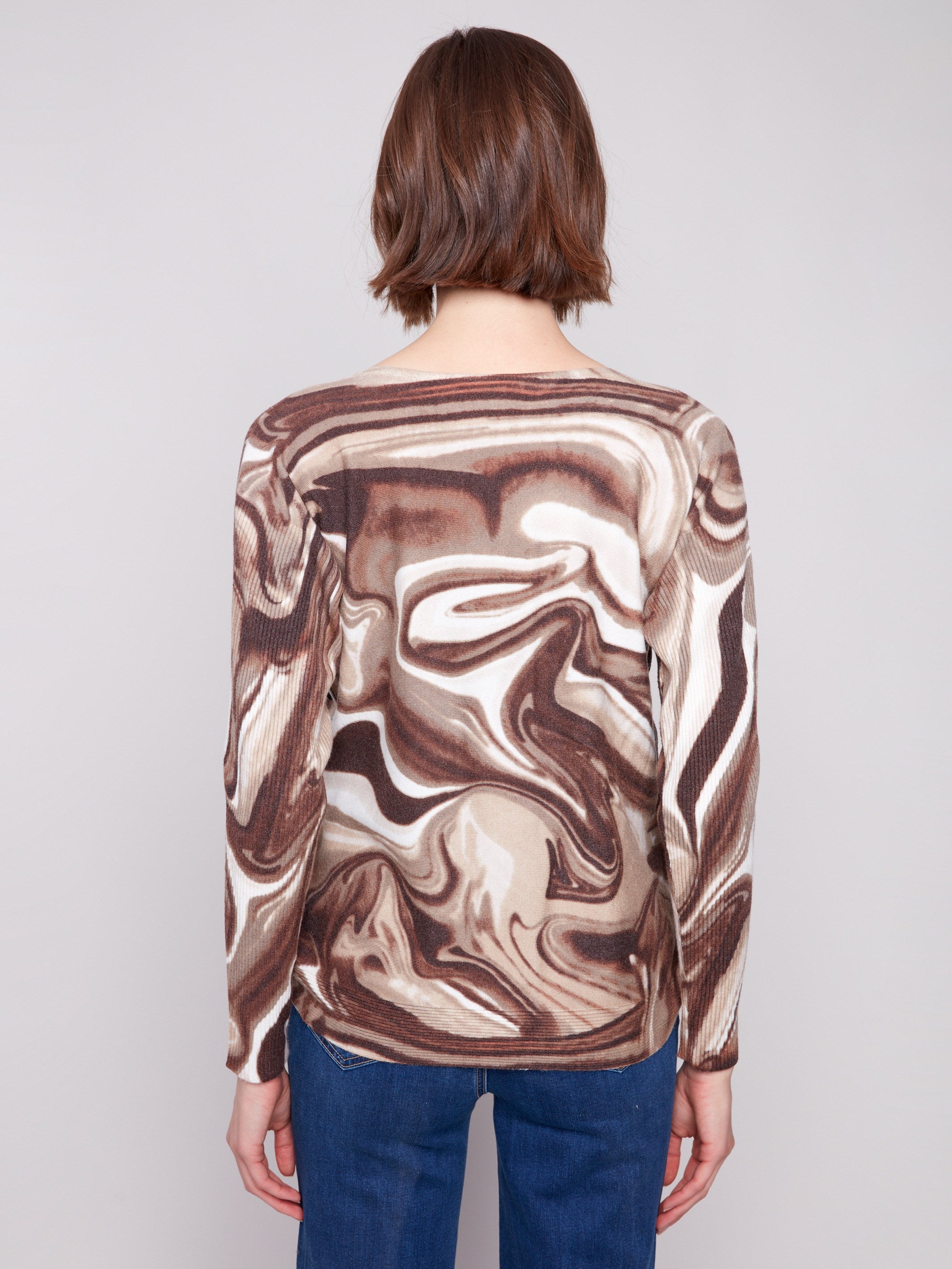 Chic sweater with boat neck and unique swirl print, perfect for versatile styling by Charlie B.