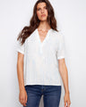 White blouse with blue stripes featuring a stylish notch neckline, crafted from 100% cotton by Charlie B.
