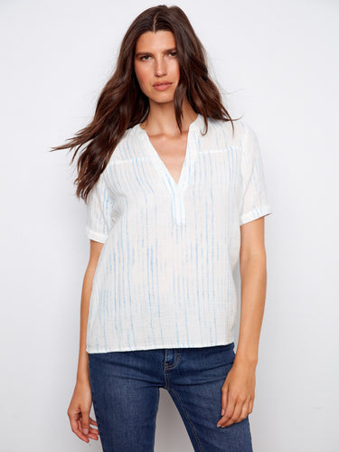 Elegant white blouse showcasing a notch neckline and subtle blue stripes, designed in breathable cotton by Charlie B.