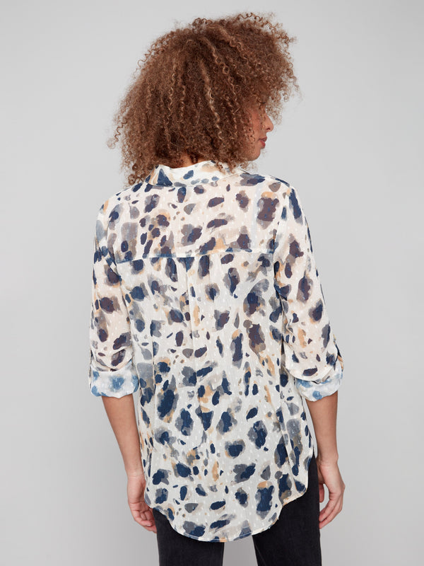 Elegant side slits enhance this semi-sheer animal print blouse by Charlie B.