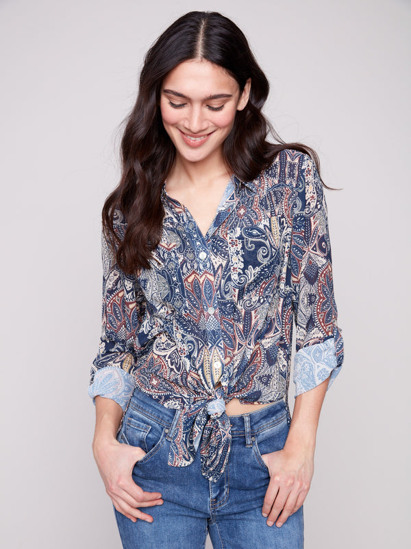 Printed paisley long-sleeve blouse with front tie, chest pockets, and side slits by Charlie B.