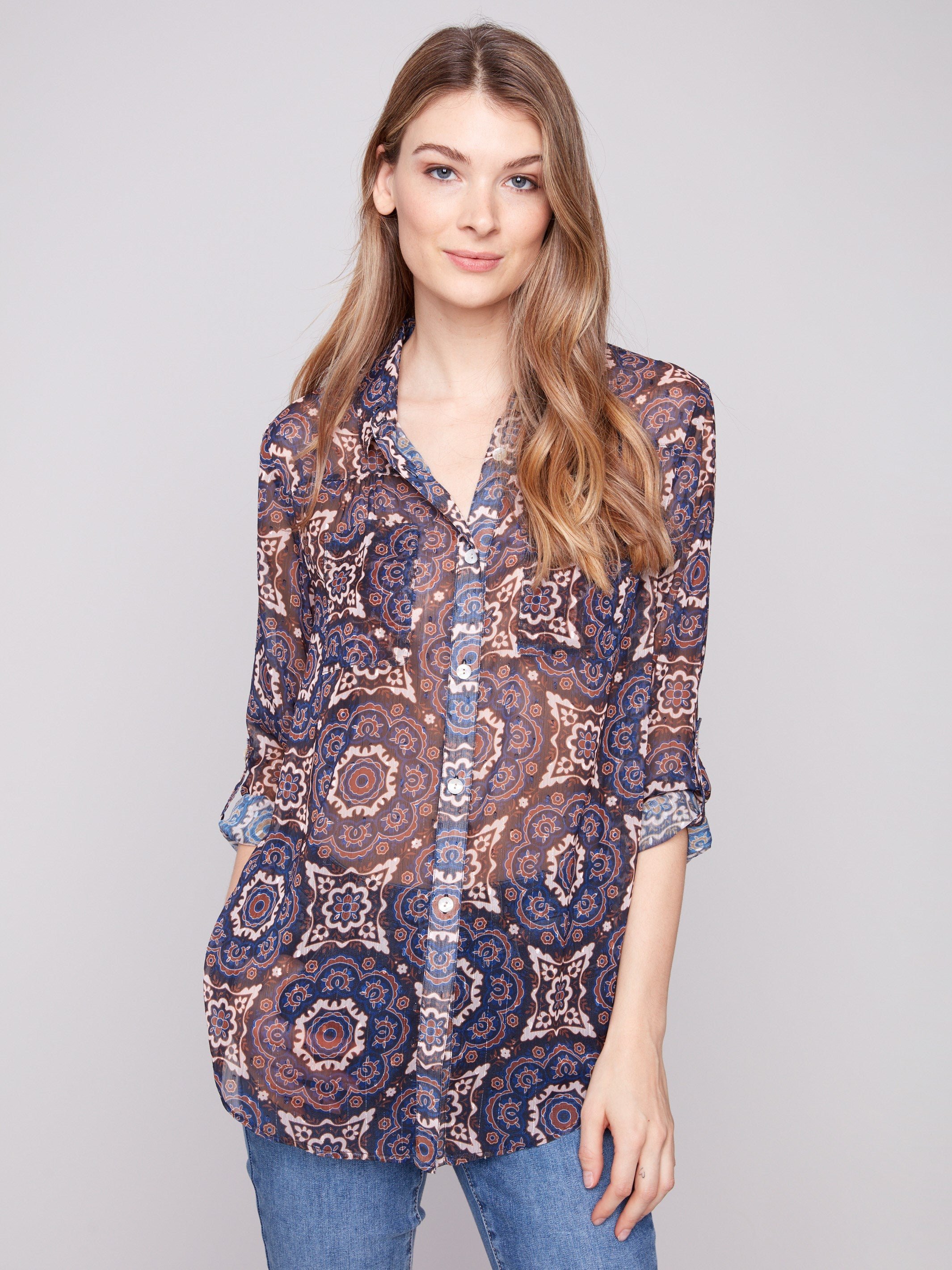 Semi-sheer blouse with a medallion print, featuring adjustable roll-up sleeves for versatile styling by Charlie B.
