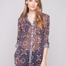 Semi-sheer blouse with a medallion print, featuring adjustable roll-up sleeves for versatile styling by Charlie B.