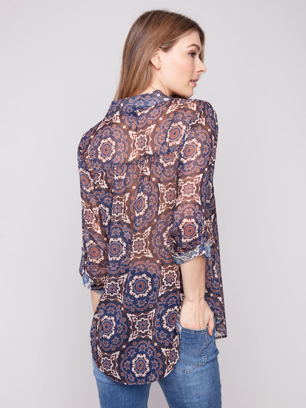 Elegant medallion design on this semi-sheer blouse, complete with adjustable sleeves and side slits by Charlie B.