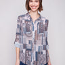 Semi-sheer patchwork blouse with chest pockets and adjustable roll-up sleeves, perfect for layering by Charlie B.