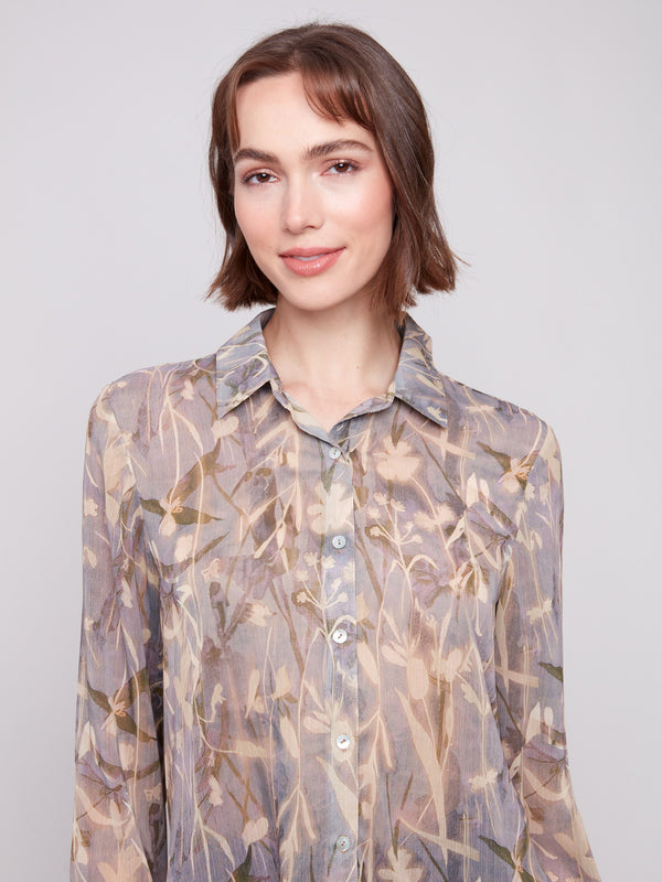 Semi-sheer fabric adds a delicate touch to this floral printed button-up shirt by Charlie B.