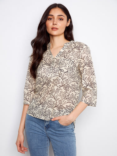 Charming blouse with a half-button design, making it versatile for various occasions. Crafted by Charlie B.
