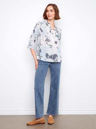 This elegant blouse showcases a Henley neckline, adding a touch of sophistication to your wardrobe. Created by Charlie B.
