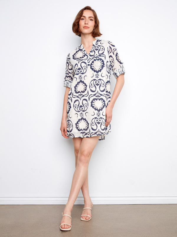 The dress features a chic chest pocket, adding both style and functionality to the overall design by Charlie B.