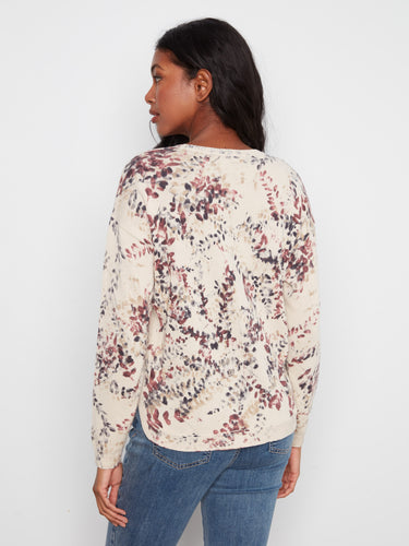 Featuring long sleeves and a crew neckline, this floral print top is versatile and stylish for any occasion. by Charlie B.