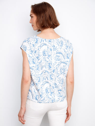 The crew neckline of this blue and white floral top provides a classic look that complements various fashion styles by Charlie B.