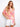 Model in a floral printed blouse with short dolman sleeves, styled with white shorts by Charlie B.