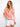Blouse with vibrant floral design and side tie detail, showcasing the boat neckline by Charlie B.