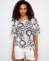 Elegant blouse with a boat neckline, featuring an intricate pattern and comfortable fit. Perfect for casual outings. By Charlie B.