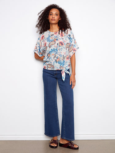 Chic short dolman sleeves add elegance to this floral top, making it a versatile addition to any wardrobe by Charlie B.