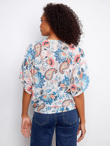The side tie at the hem of this floral top offers an adjustable fit and adds a touch of flair to your look by Charlie B.