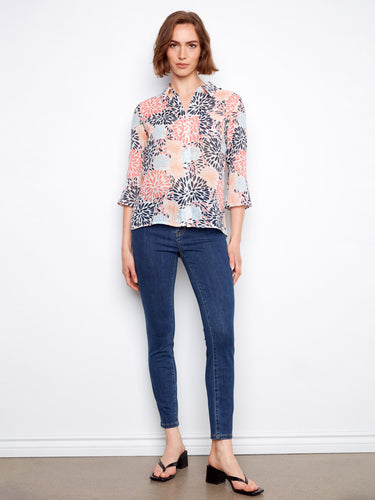 Designed with adjustable roll-up sleeves, this floral blouse offers adaptability and chic comfort by Charlie B.